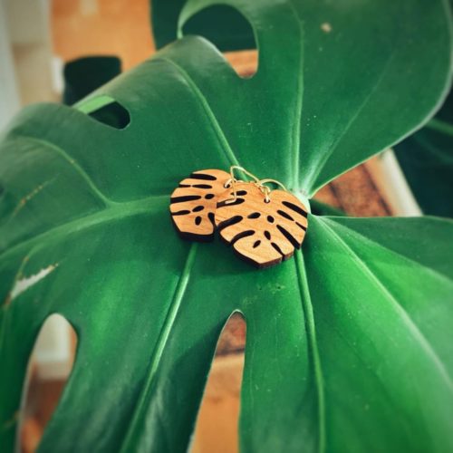 Monstera Cherry-Wood Leaf Earrings Showcased on Plant